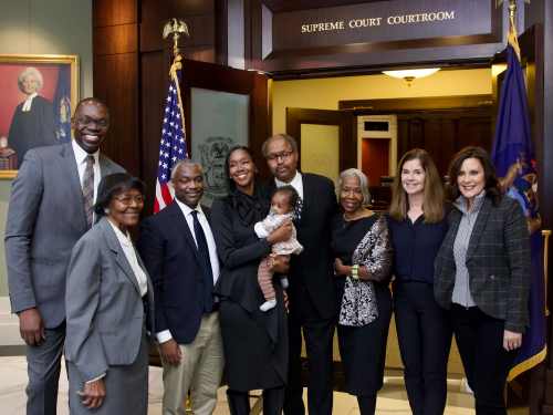 Kyra Harris Bolden stands outside the courtroom after being appointed to the Michigan Supreme court alongside her family and Governor Gretchen Whitmer.